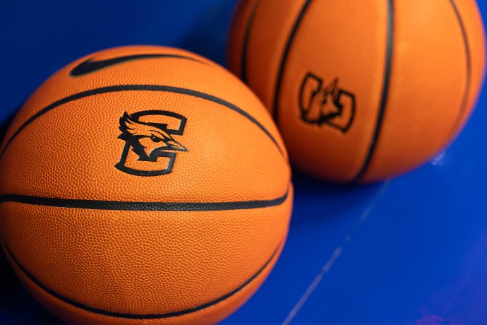 Two basketballs with Creighton and BIG EAST logos rest on a blue surface before the Xavier-Creighton game.