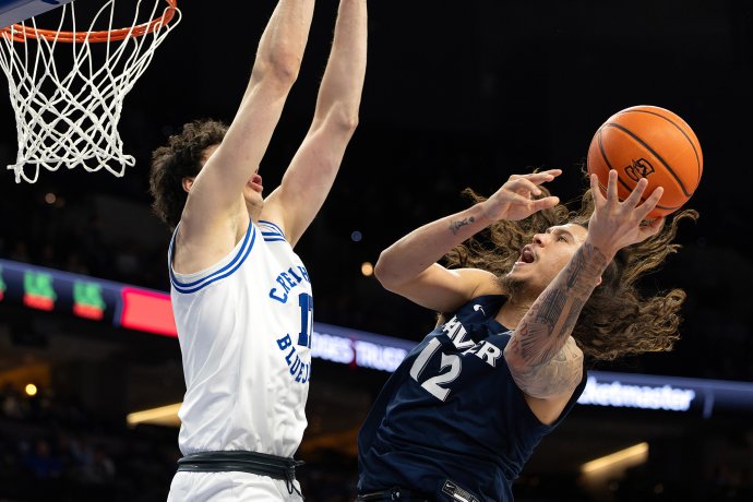 Xavier forward Tre Carroll attempts a shot against Creighton forward Kerem Konan near the basket.