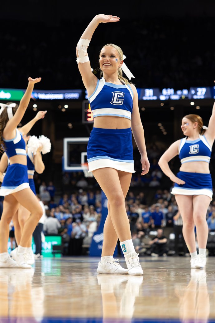 A Creighton cheerleader performs on the basketball court during a first-half timeout.