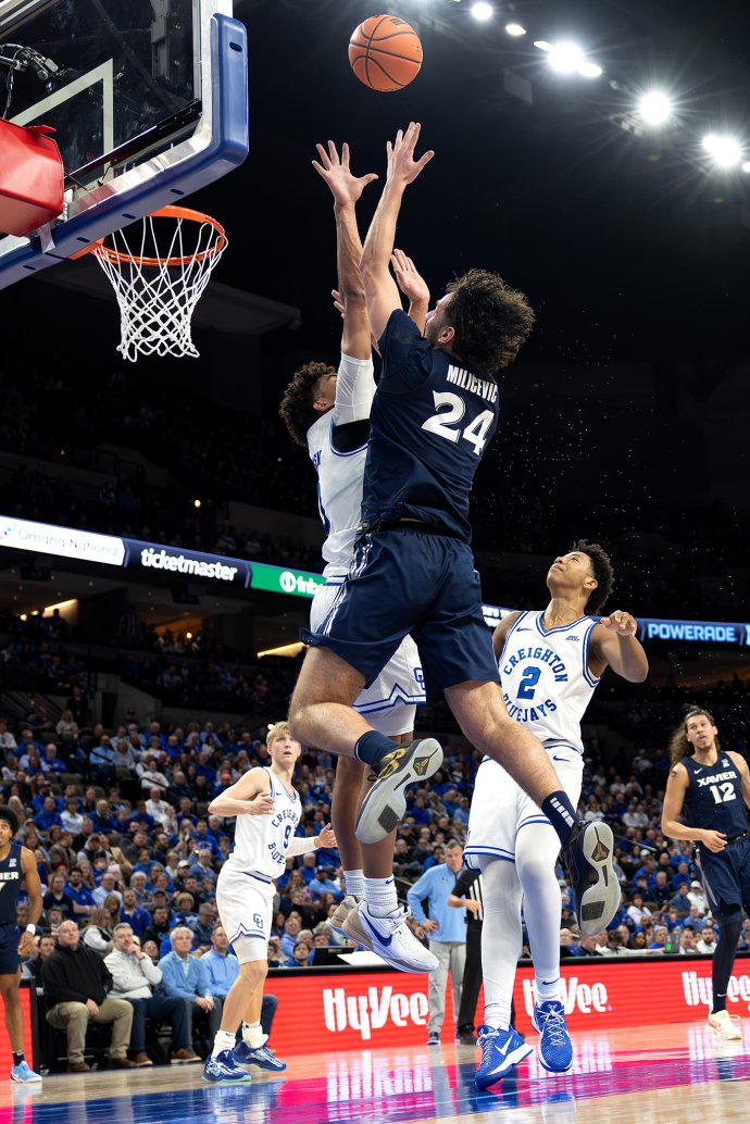 Xavier forward Jovan Milicevic shoots over Creighton forward Jasen Green near the basket in the first half.