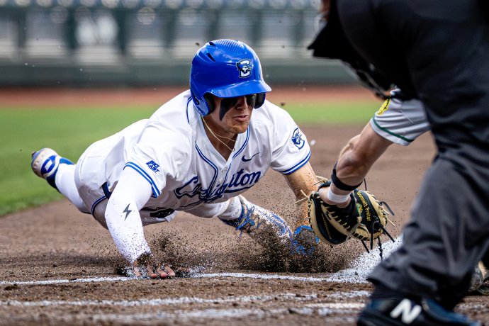 Creighton Bluejays infielder BEN NORTH (11) slides past a tag to score during the fourth inning of a game against the North Dakota State Bison at Charles Schwab Field on April 22, 2025.