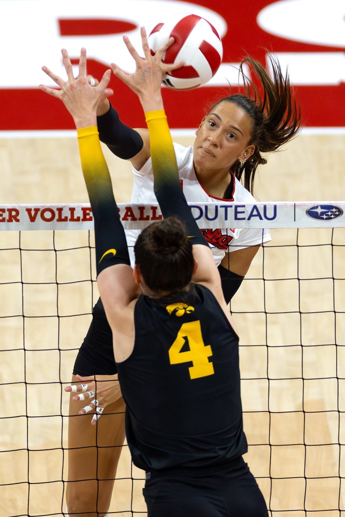 HARPER MURRAY (27) of the Nebraska Cornhuskers of the Nebraska Cornhuskers spikes the ball into CLAIRE AMMERAAL (4) of the Iowa Hawkeyes during the second set of a volleyball match at Bob Devaney Sports Center on Nov. 20, 2025.
