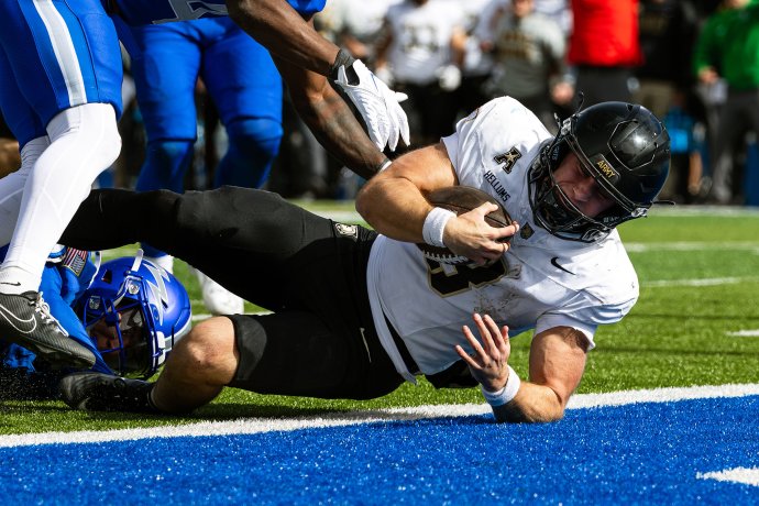 Army quarterback Cale Hellums dives across the goal line for a fourth-quarter touchdown against Air Force.