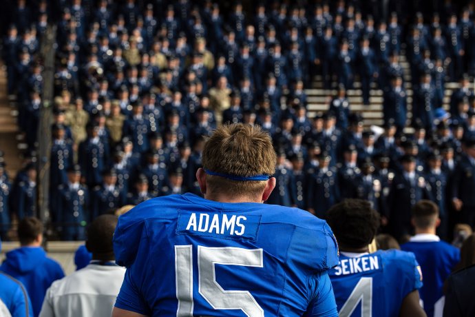 Air Force defensive lineman Jackson Adams stands among U.S. Air Force Academy cadets during the alma mater after the game.