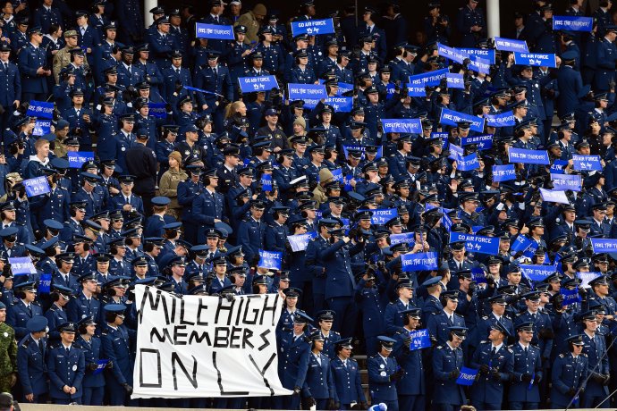 U.S. Air Force Academy cadets fill the stands at Falcon Stadium, many holding Air Force signs during the game against Army.