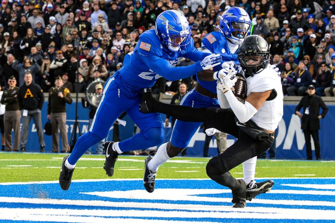 Army slot back Noah Short secures a touchdown catch in the end zone as two Air Force defenders close in.