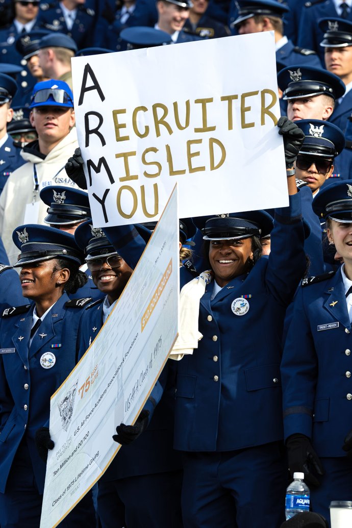 U.S. Air Force Academy cadets hold signs while cheering from the stands during the game against Army.