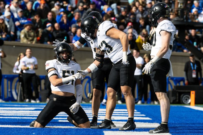 Army linebacker Andon Thomas is congratulated by teammates after breaking up a play against Air Force.