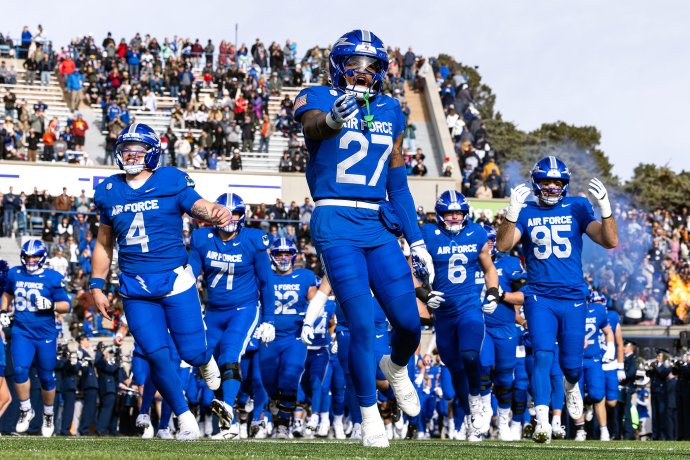Air Force football players run onto the field before their game against Army at Falcon Stadium.