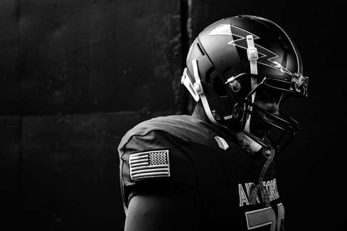 An Air Force football player wearing a helmet exits the tunnel before the game against Army.