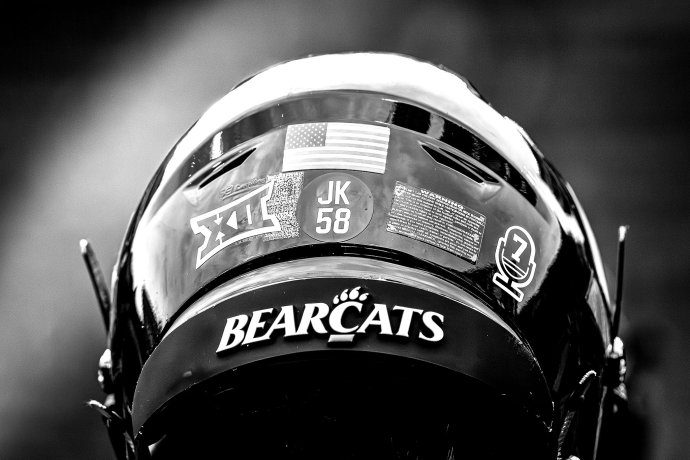 Close-up view of the back of a Cincinnati Bearcats football helmet during pregame activities.