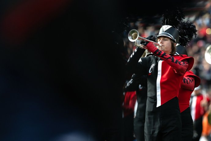 Members of the Cincinnati Bearcat Marching Band perform on the field during halftime.
