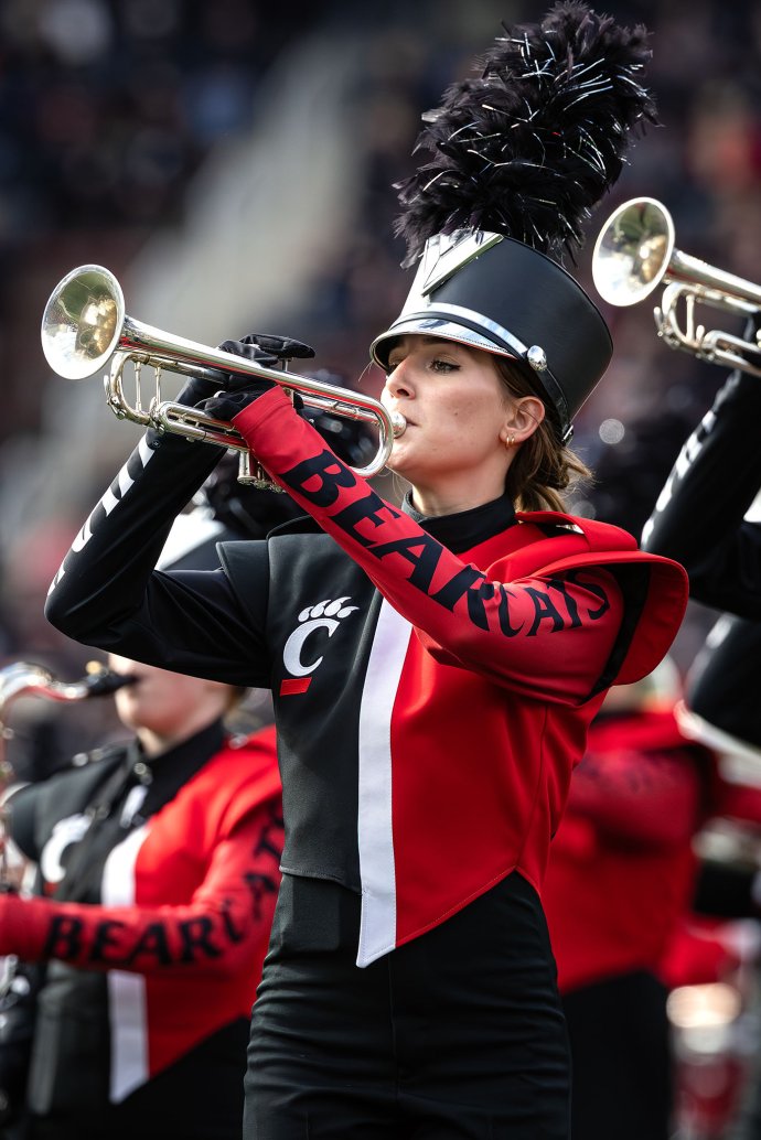 Members of the Cincinnati Bearcat Marching Band perform on the field during halftime.
