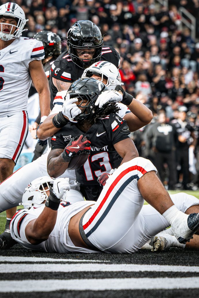 Cincinnati running back Zion Johnson (13) scores on a 3-yard touchdown run against Arizona.