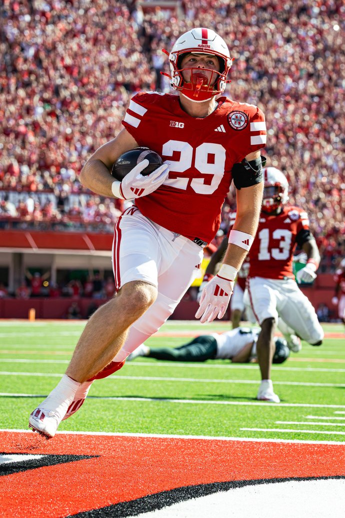 Nebraska tight end Carter Nelson (29) returns a punt blocked by Jamir Conn (13) for a 3-yard touchdown against Michigan State.