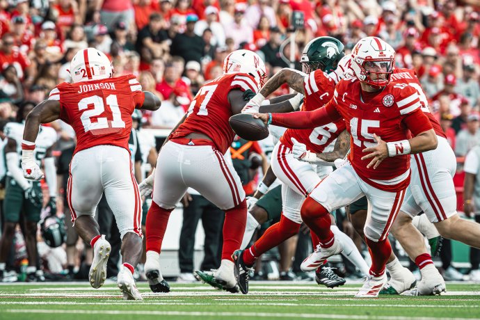 Nebraska quarterback Dylan Raiola (15) fakes a handoff as the Cornhuskers run a play against Michigan State.