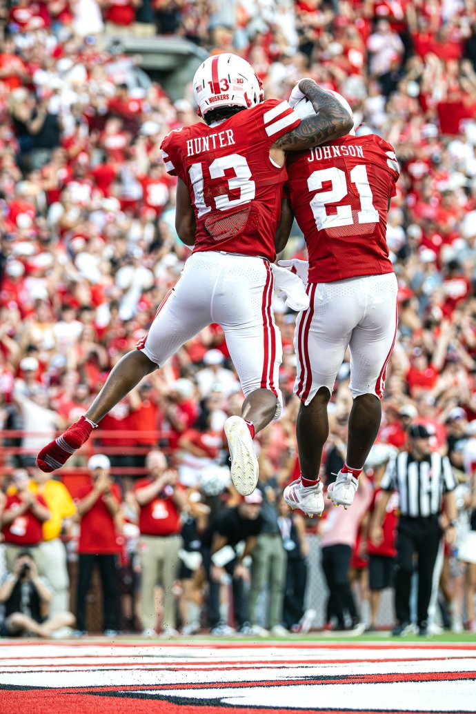 Nebraska wide receiver Nyziah Hunter (13) celebrates with running back Emmett Johnson (21) after a 59-yard touchdown reception, with Hunter missing a shoe.