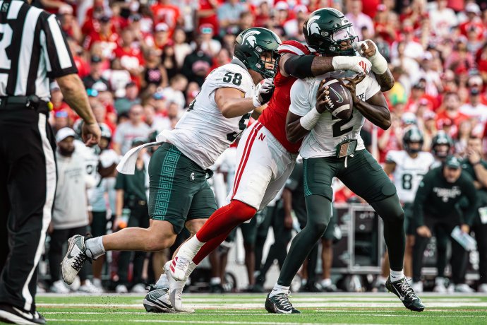 Michigan State quarterback Aidan Chiles (2) is sacked by a Nebraska defender.