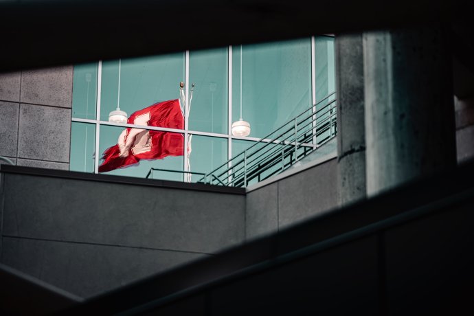 A reflection of a Nebraska flag at Memorial Stadium during the Nebraska-Michigan State football game.