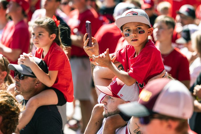 A young Nebraska fan waits for the Cornhuskers to arrive at Memorial Stadium before the game against Michigan State.