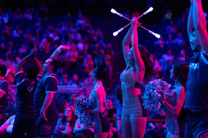 Omaha Supernovas twirler Stefaffany Lien raises illuminated batons during the team’s tunnel entrance.
