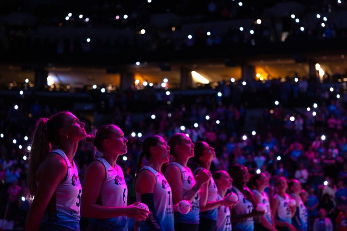 Omaha Supernovas players stand on the court under arena lights during pregame introductions.