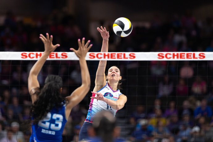 Omaha Supernovas outside hitter Sarah Parsons (11) attacks over the net against Dallas.