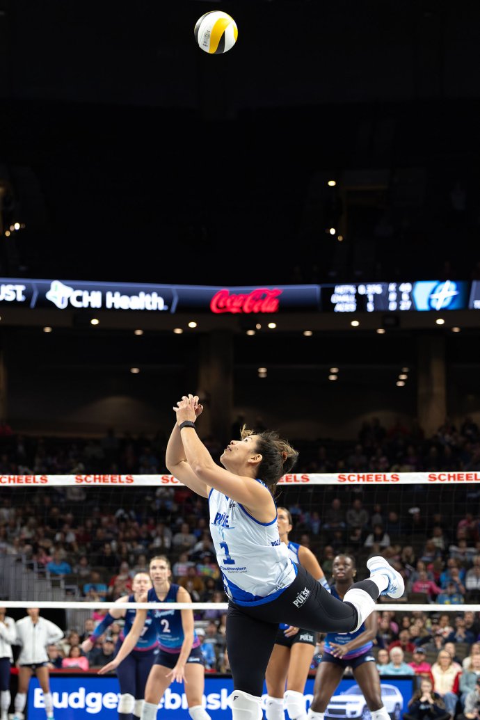 Dallas Pulse setter Natalia Valentin-Anderson (1) reaches overhead to keep the ball in play.