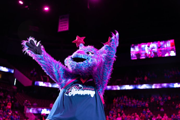 Starla, the Omaha Supernovas mascot, raises an arm while being introduced to fans before the match against the Indy Ignite.