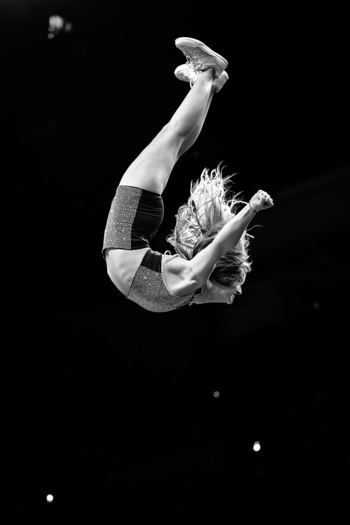 An Omaha Supernovas Hype Squad member performs an aerial flip during a third-set timeout.