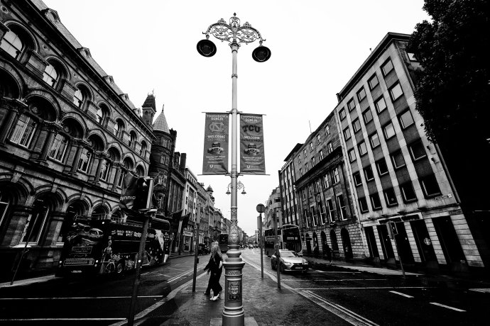 North Carolina and TCU banners hang from a lamp post above a wet street in Dublin.