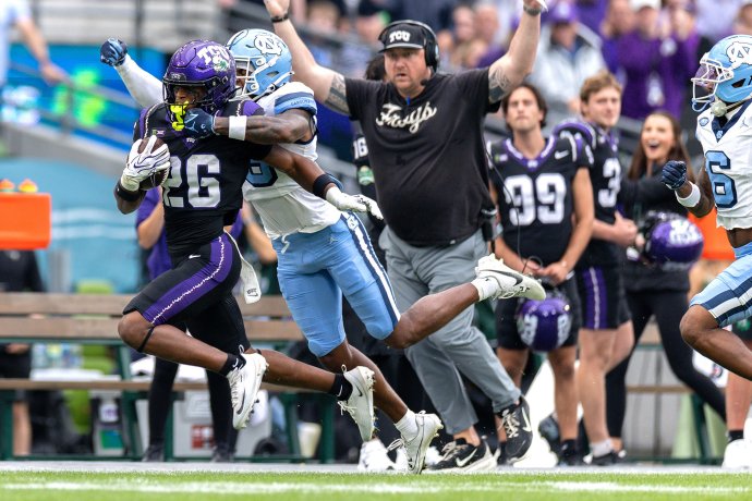 TCU running back Jeremy Payne is brought down by North Carolina defensive back Jaiden Patterson after a long gain.