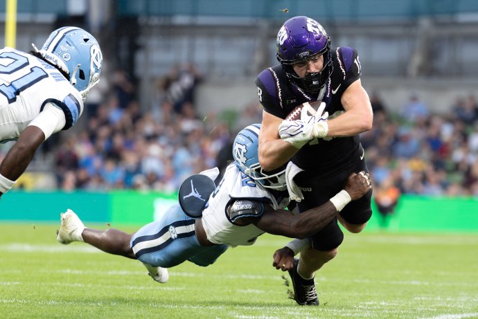 North Carolina defensive back Kaleb Cost makes a diving tackle on TCU wide receiver Ed Small.