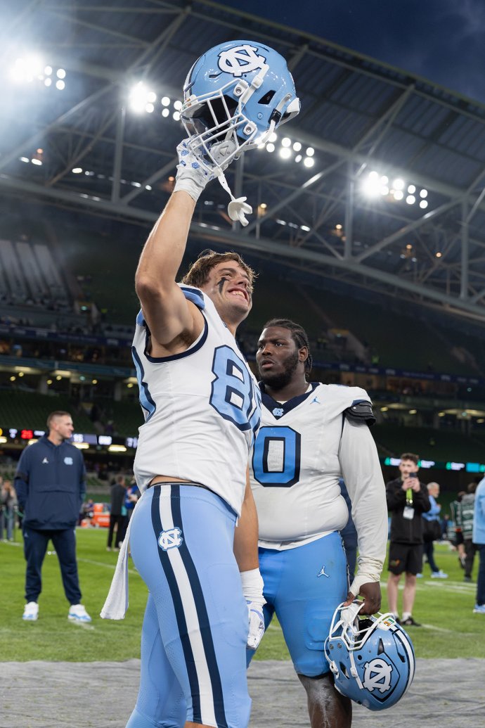 North Carolina tight end Deems May raises his helmet following the Tar Heels’ victory over TCU.