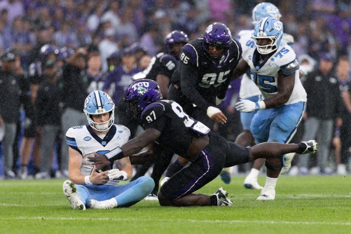 TCU linebacker Paul Oyewale makes late contact with North Carolina quarterback Billy Edwards Jr.